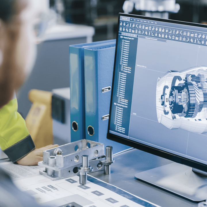 A man looks at computer screen with cad image